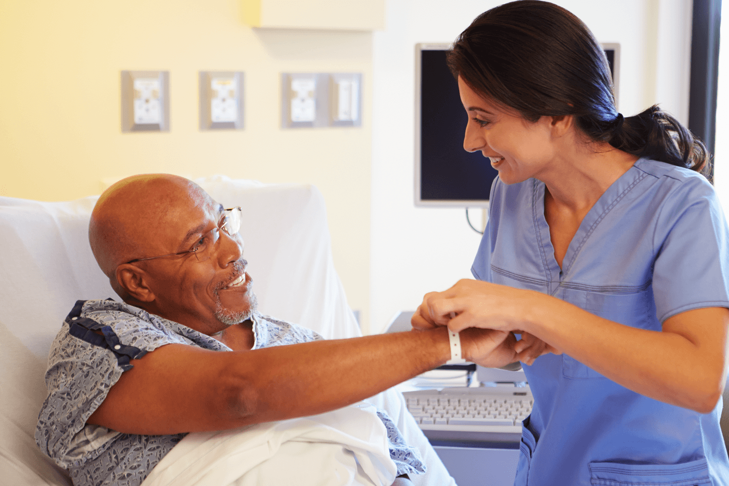 Medical professional looking a patient wristband